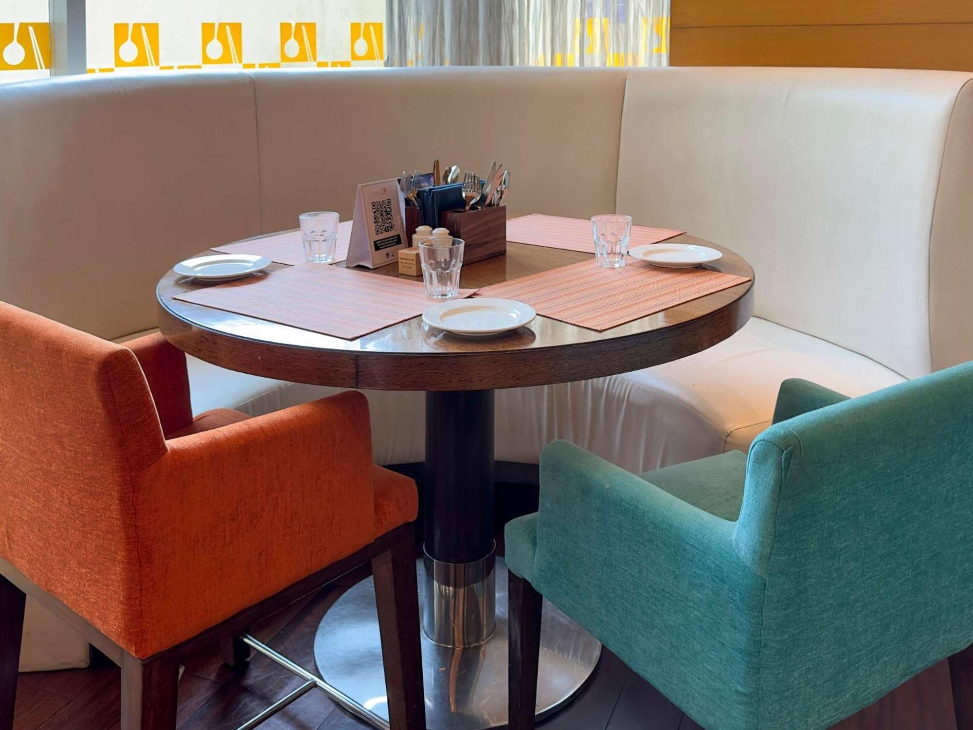 Novotel Pune Viman Nagar Road Exterior photo A table and chairs in a restaurant
